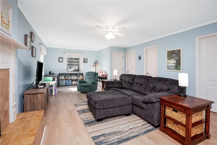 This inviting living room boasts wood flooring and a classic fireplace, creating a warm and welcoming atmosphere.