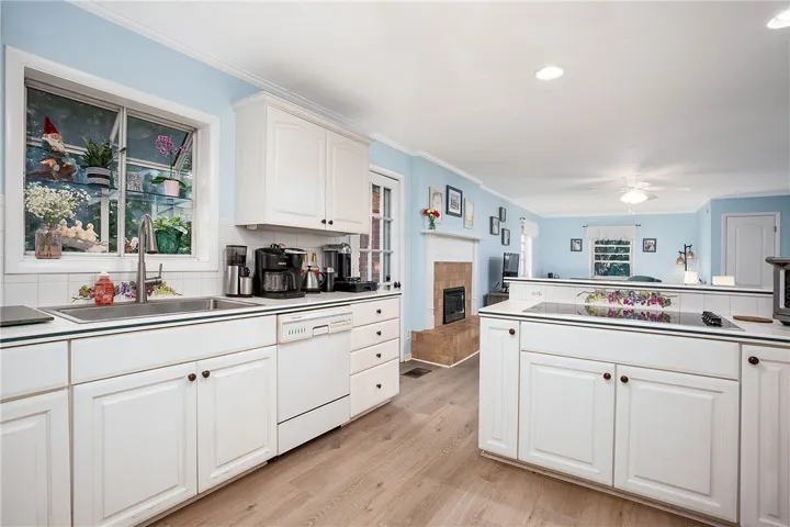 This spacious kitchen offers abundant counter space and seamlessly connects to a cozy living area.