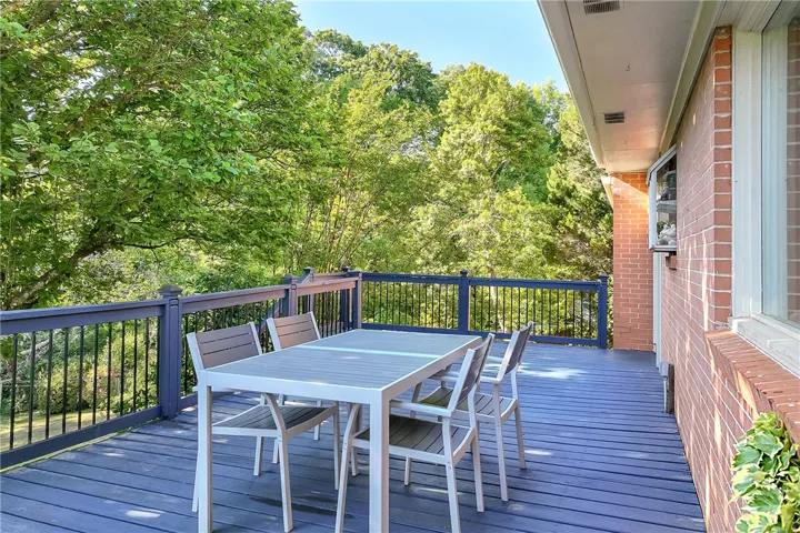 This inviting outdoor deck offers tranquil views and ample space for al fresco dining.