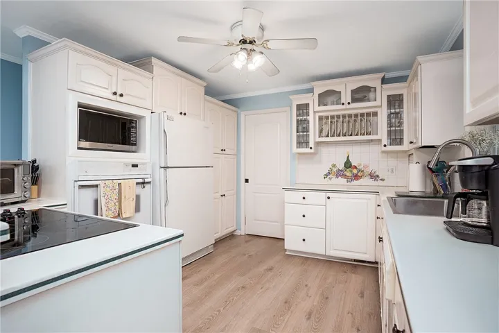 This spacious kitchen offers ample storage and modern amenities, creating an inviting culinary space.