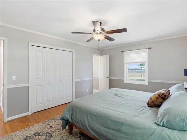 This spacious bedroom offers comfortable living with elegant hardwood flooring.