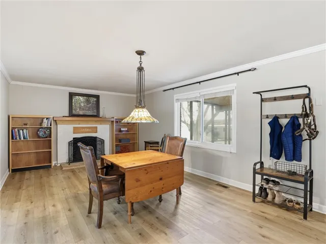 This inviting dining area features a cozy fireplace and abundant natural light.
