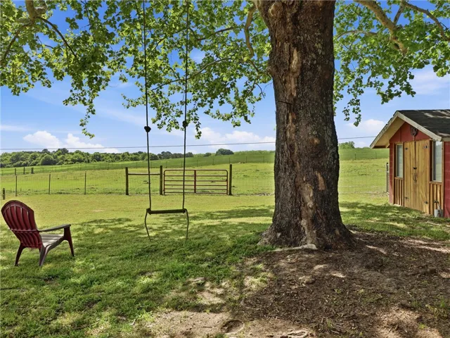 This outdoor space offers expansive views and a charming outbuilding.