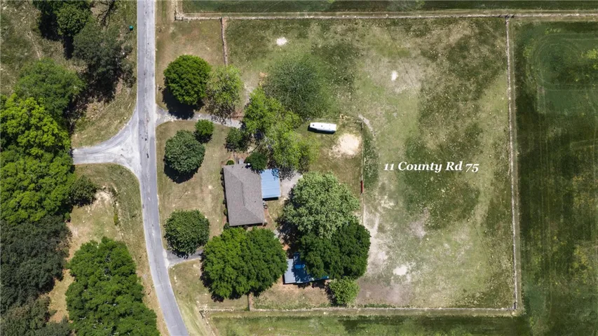An aerial view captures the property, highlighting its secluded location and lush surroundings.