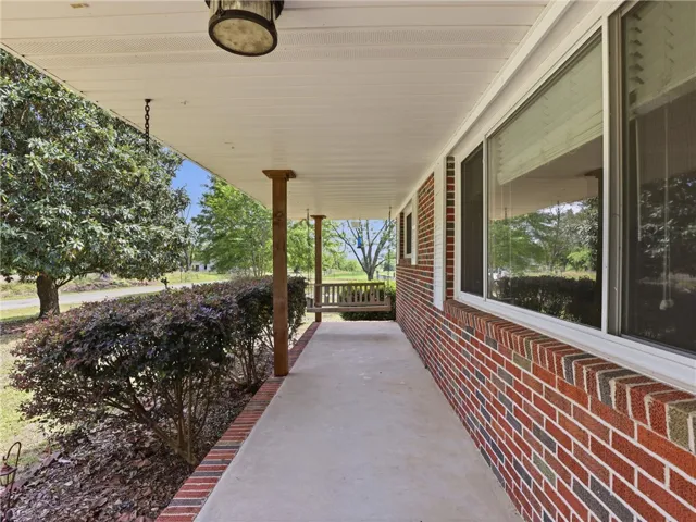 This charming residence features a welcoming front porch, perfect for relaxing.