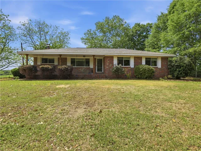 This classic brick residence presents a welcoming facade with a well-maintained lawn.