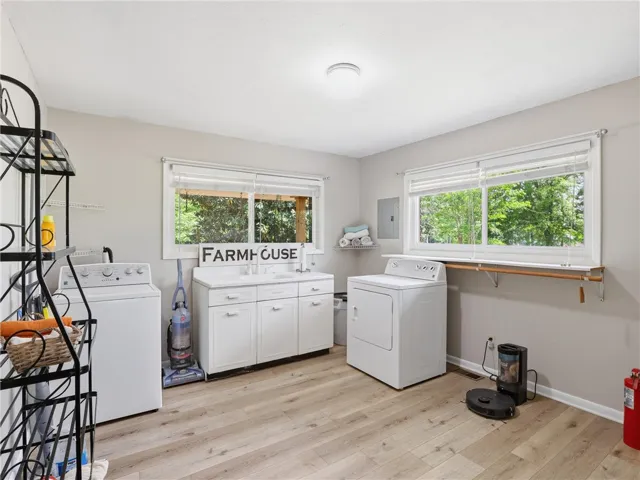 Functional laundry room featuring windows offering natural views.