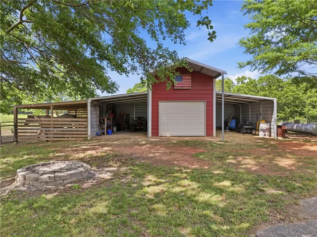 This property features a spacious barn and versatile outdoor structures, perfect for various uses.