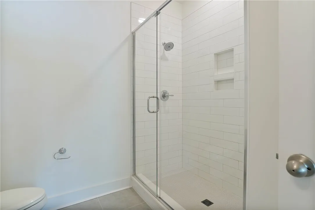 Primary bathroom, full tile walk in shower with glass doors!
