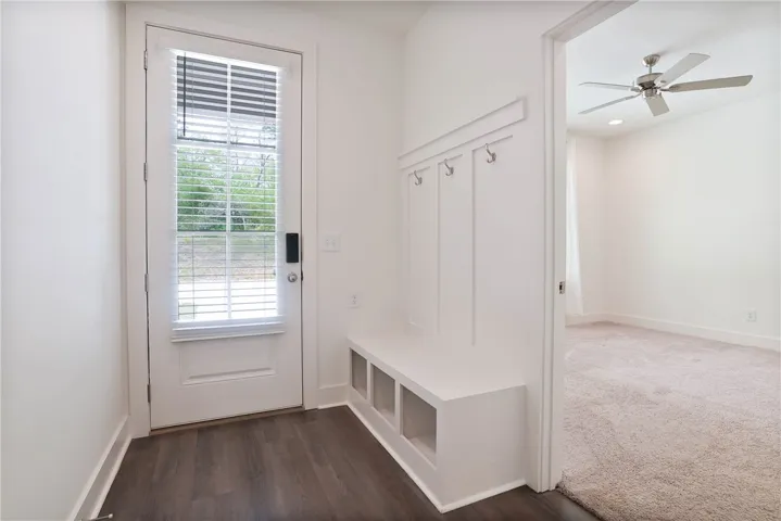 Rear Entryway, drop zone, and entrance to primary suite