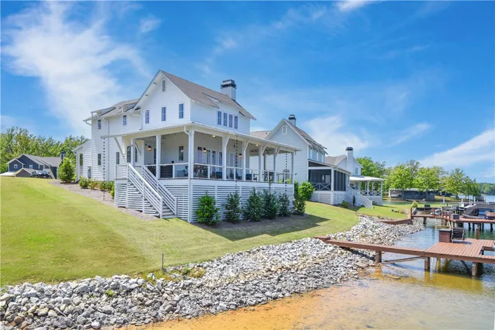 This exquisite lakeside dwelling offers an expansive deck and private dock for ultimate waterfront living.