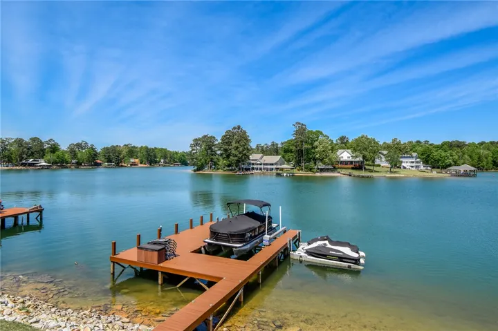 This serene waterfront setting includes a private dock, offering direct access to tranquil waters.