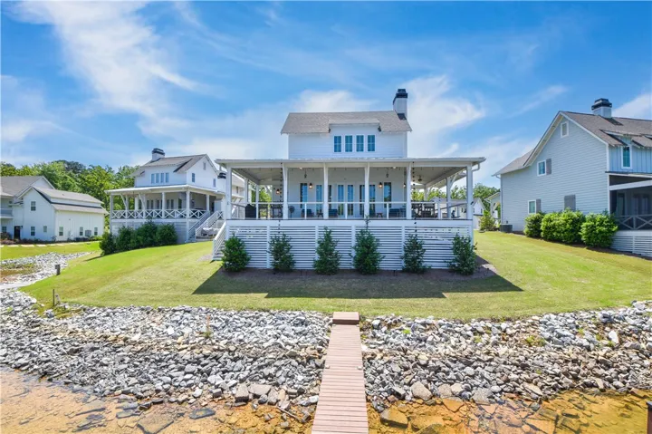 This charming lakeside home features a spacious deck perfect for enjoying waterfront views and outdoor living.