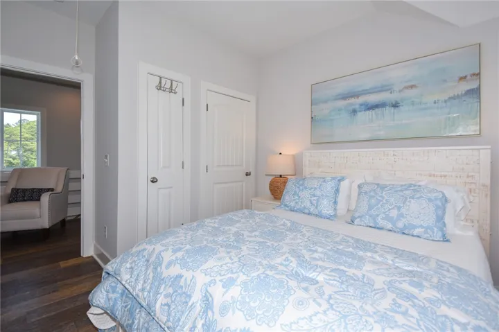 This cozy bedroom features warm wood flooring, offering a peaceful retreat.