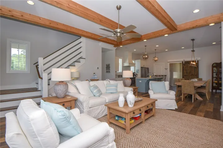 This airy living space features warm wood beams and an inviting open-concept layout.