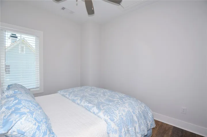 This cozy bedroom features a window with blinds, creating a comfortable and private space.