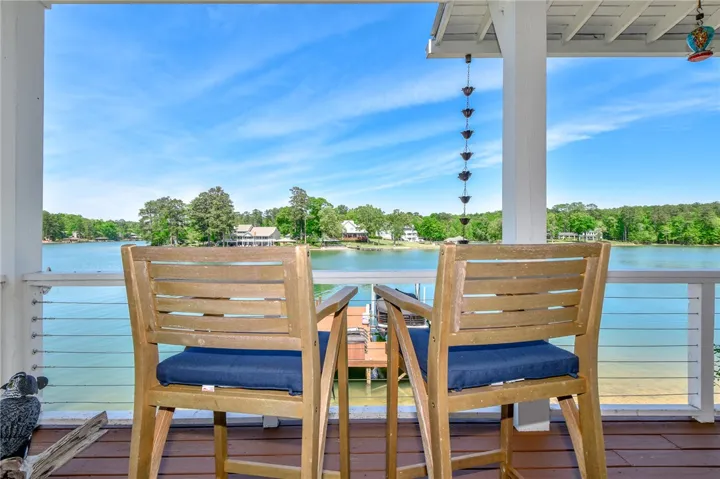 This inviting porch offers captivating views of the tranquil lake and surrounding landscape.
