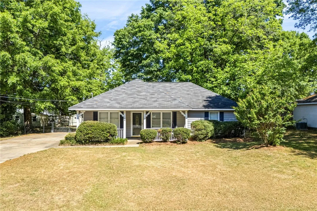 This charming residence features a well-maintained exterior and a welcoming front porch, perfect for relaxing at the end of the day.