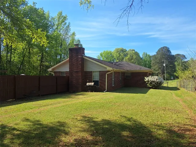 This residence features a well-maintained yard and a durable brick exterior.