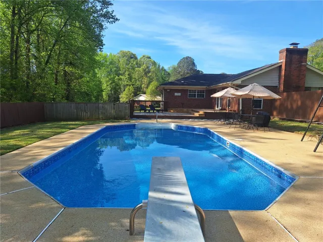 This private outdoor oasis features a refreshing pool, spacious patio, and a beautiful backyard setting.