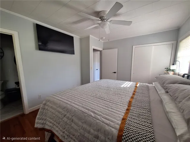 Relax in comfort with wood floors and a ceiling fan, creating a serene personal retreat.