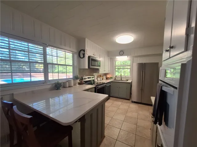 This spacious kitchen offers ample counter space and natural light, perfect for culinary endeavors.