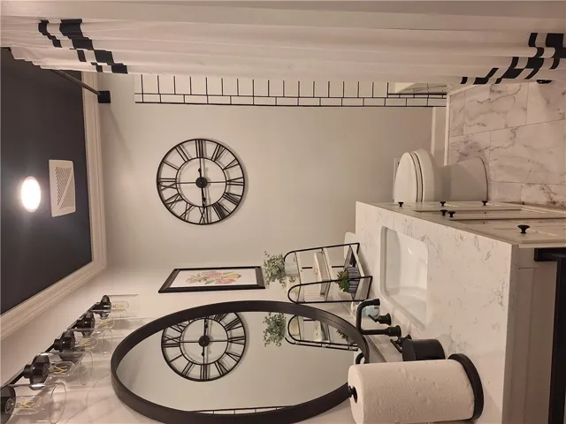 This clean and bright bathroom features elegant marble accents and modern fixtures.