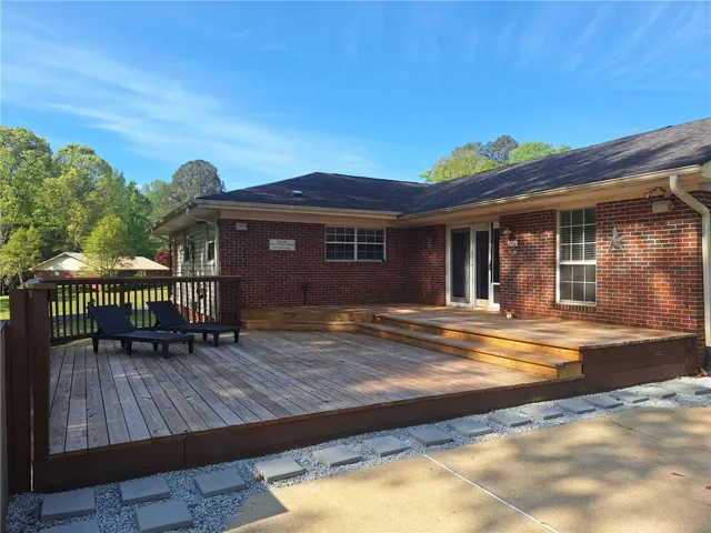 Enjoy outdoor living on this expansive tiered wood deck, perfect for relaxation and entertaining.