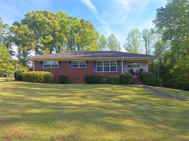 This charming home offers a spacious yard and classic brick construction.