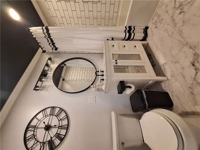 This clean bathroom features a sleek vanity and modern fixtures, creating a refreshed and inviting space.