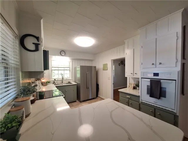 This kitchen features sleek countertops, modern appliances, and ample cabinet space.