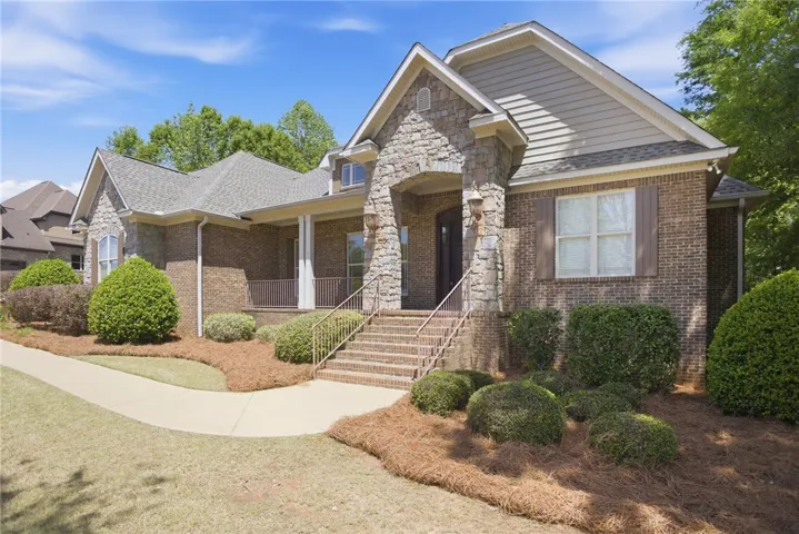 This charming home showcases a brick exterior with stone accents and a welcoming entryway.