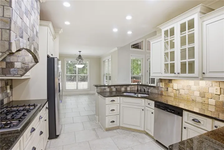 This luminous kitchen features premium appliances and ample counter space for culinary pursuits.

Furnishings shown in some photos are digitally added and not present in the home.
