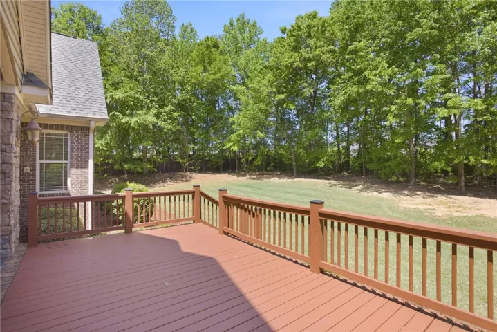 This spacious deck offers a seamless transition to the expansive private yard, perfect for outdoor enjoyment.