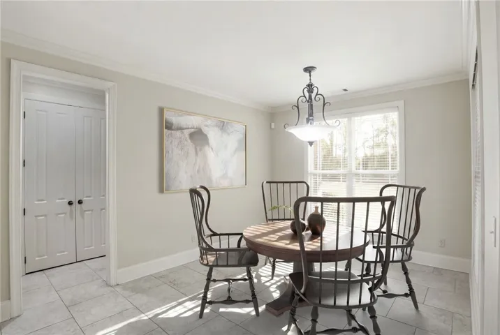 This bright dining area features an elegant chandelier and durable tile flooring, perfect for everyday living.
Virtually Staged.