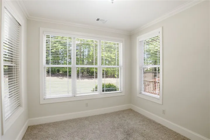 Bright and airy room with large windows, inviting ample natural light.