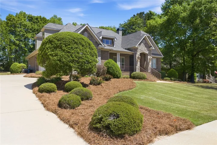 This grand residence showcases a classic architectural style with meticulous landscaping.