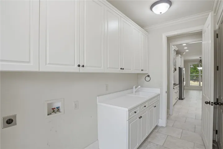 This bright laundry room offers practical functionality and seamless style for daily tasks.