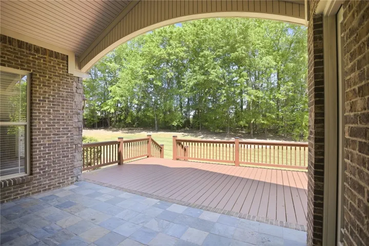Enjoy outdoor living on this expansive deck and patio, offering seamless views of surrounding nature.