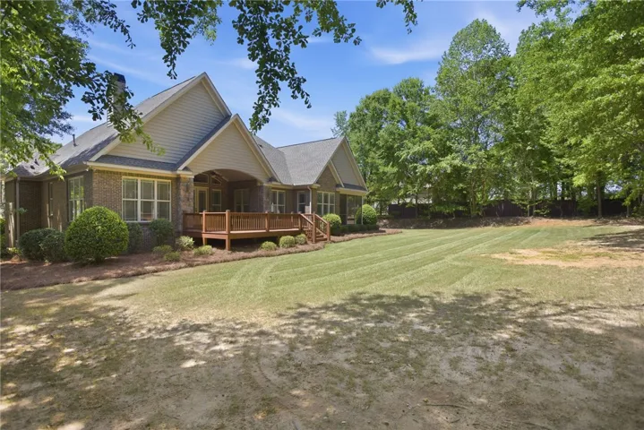 This residence offers a spacious backyard with a charming deck, perfect for outdoor enjoyment.