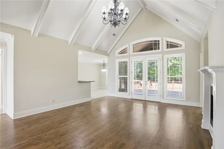 This airy living space features soaring vaulted ceilings and gleaming hardwood floors, perfect for gatherings.