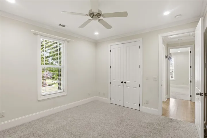 This bright and airy room offers comfort and style with plush carpeting and natural light.