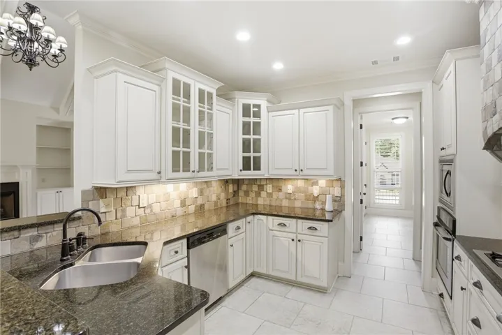 This spacious kitchen offers ample cabinet storage and modern appliances.