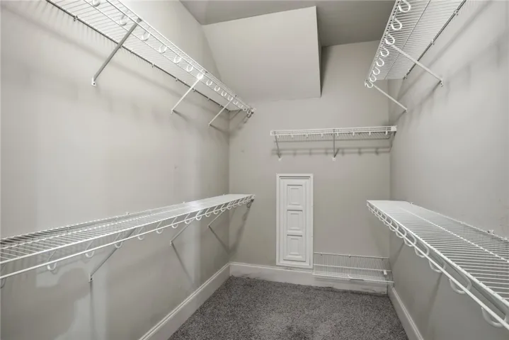 This spacious walk-in closet features ample wire shelving for optimal organization.
