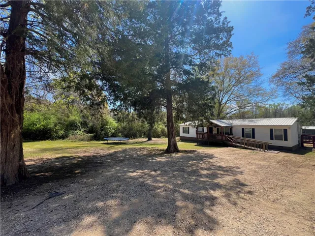 This charming home offers ample outdoor space and convenient ramp access to the entrance.