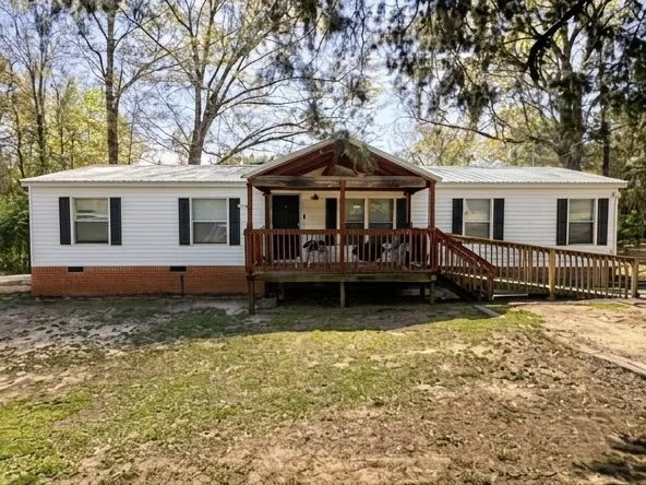 This charming home offers a welcoming front porch and a convenient access ramp.