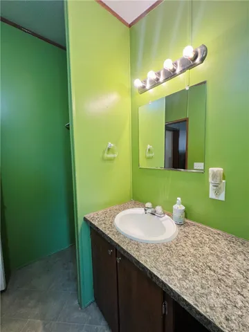 This bathroom features a functional vanity with a sleek countertop.