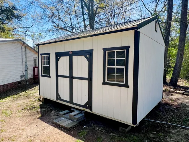 This newly built shed offers practical storage and enhances outdoor living with its crisp design.