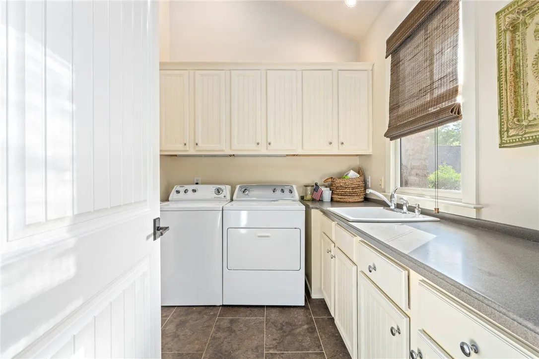 The laundry room allows for ample storage and a countertop for folding.