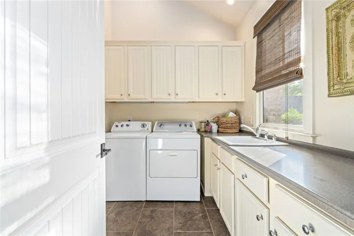 The laundry room allows for ample storage and a countertop for folding.